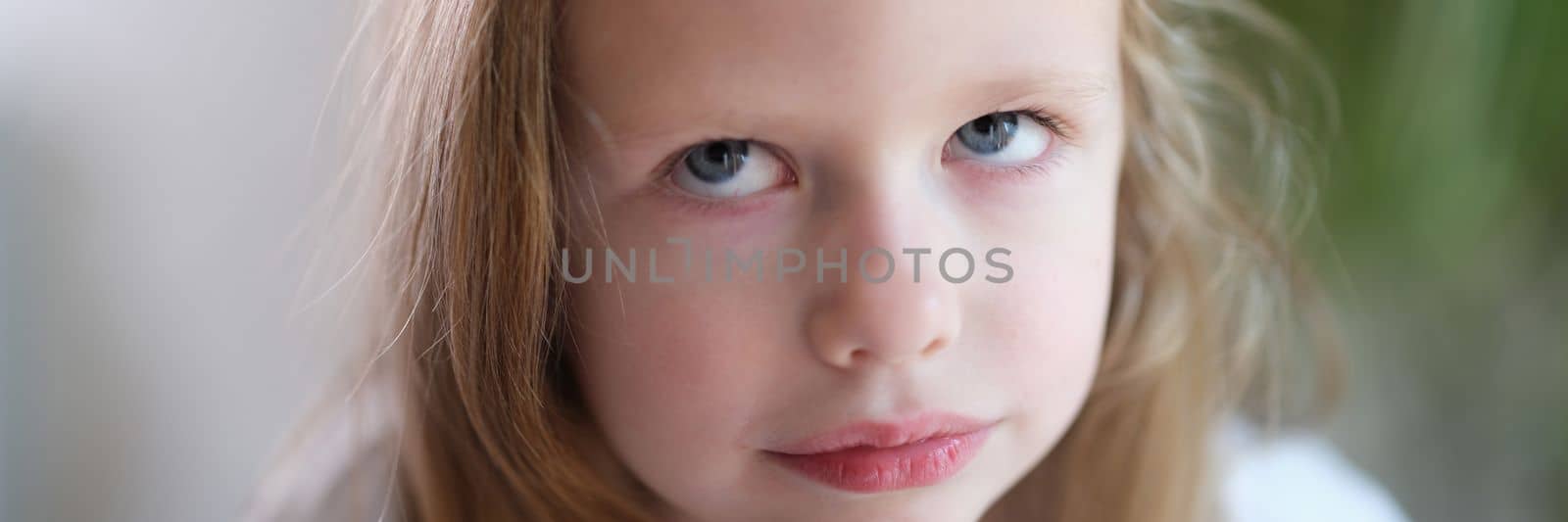 Portrait of pensive serious little child girl looks up. Finding solution and children emotions concept