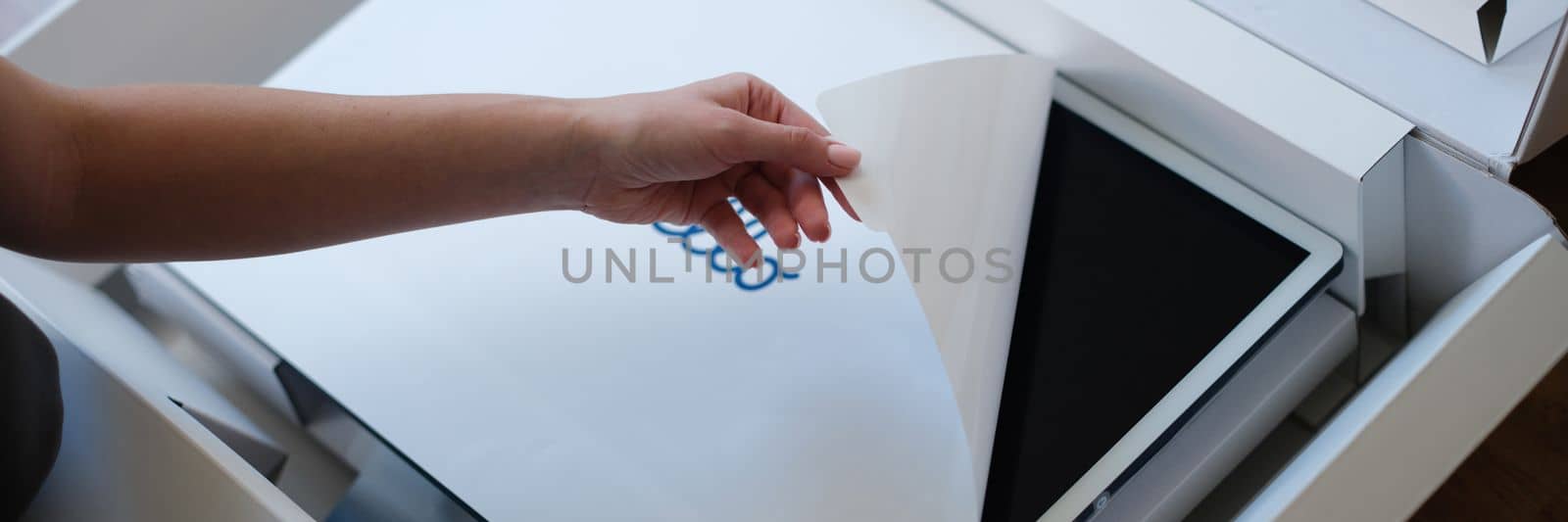 Tbilisi, Georgia - June 21, 2022: Person removes the protective film from new New iMac monitor by kuprevich