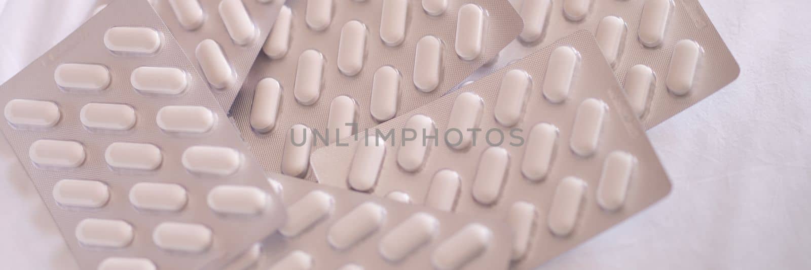 Heaps of blisters with medical pills on table. Taking medications and choosing tablets concept