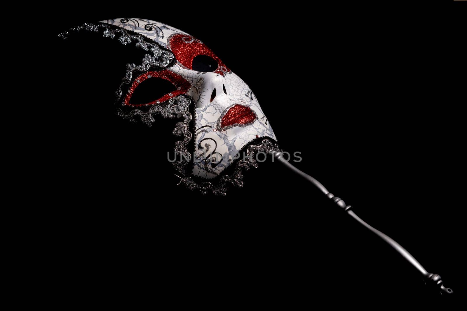 venetian carnival mask on black background by joseantona