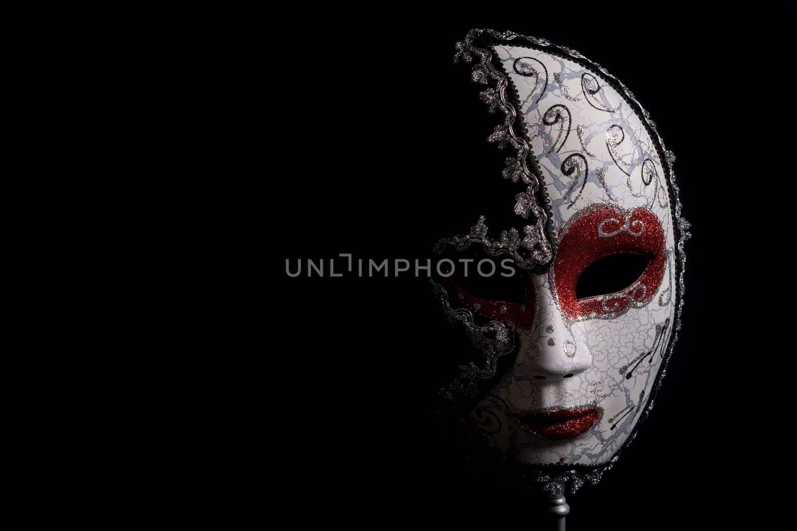 venetian carnival mask on black background by joseantona