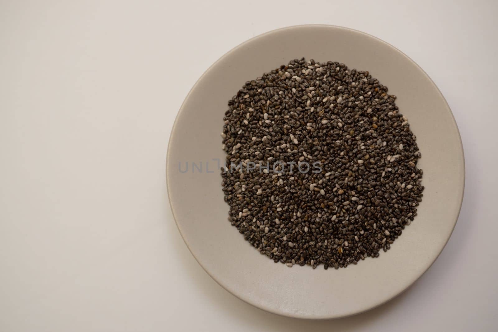 chia seeds on a white plate by joseantona