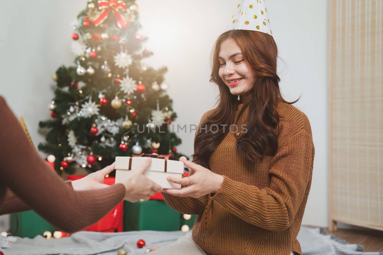 Cheerful lady surprised of the present after the opening in the gift box. Marry Christmas and Happy Holidays and New Year eve celebrating concept.