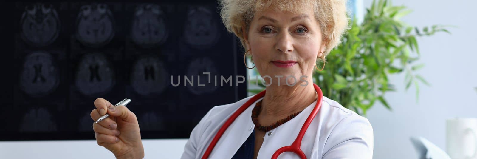 Portrait of elderly woman doctor in field of medicine. Brain examination and dementia concept