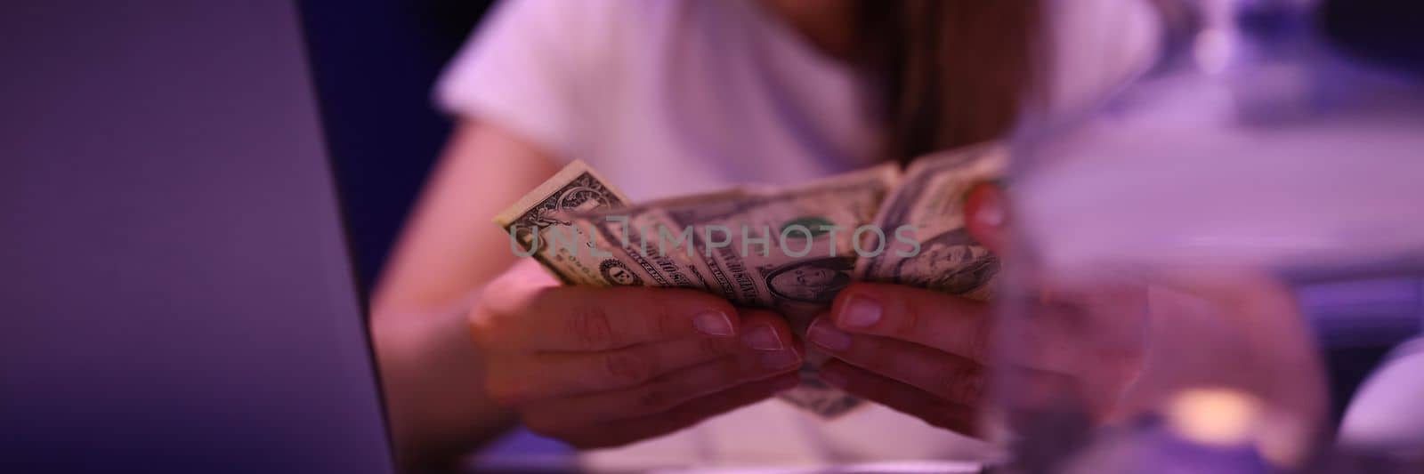 Bankrupt woman with piggy bank and dollars by kuprevich