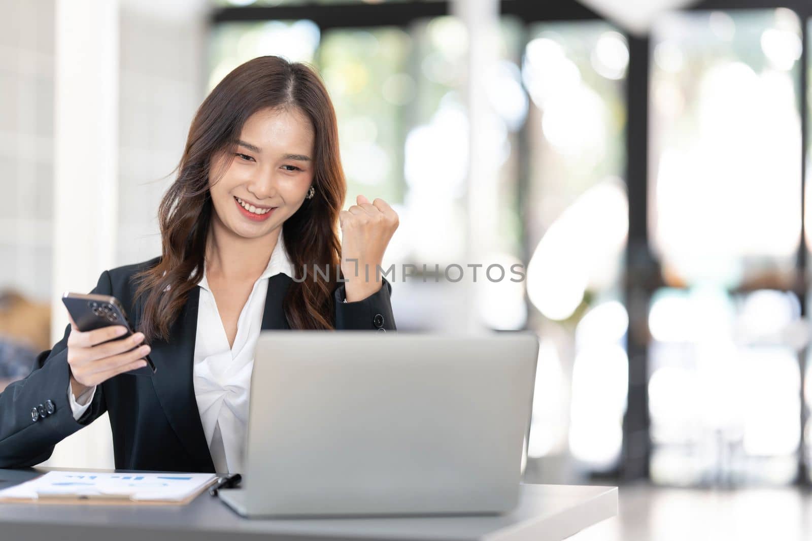 Beautiful asian woman using laptop computer, exciting and celebrating with good news of business successful. Small business startup concept. by wichayada