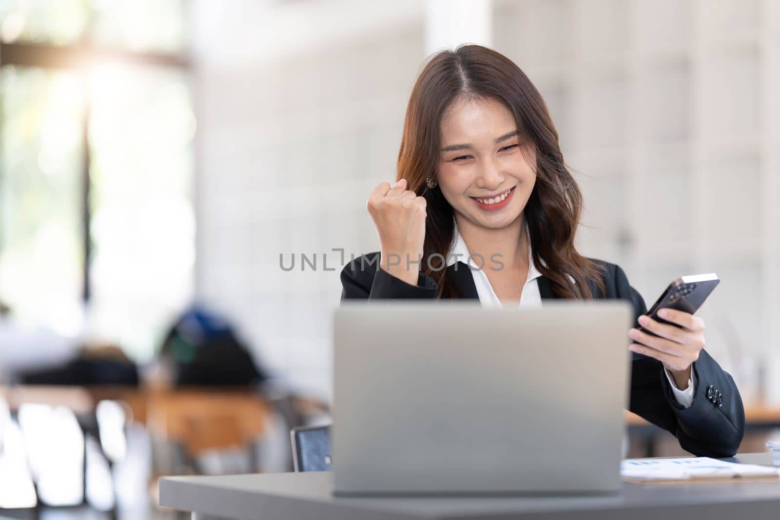 Beautiful asian woman using laptop computer, exciting and celebrating with good news of business successful. Small business startup concept...