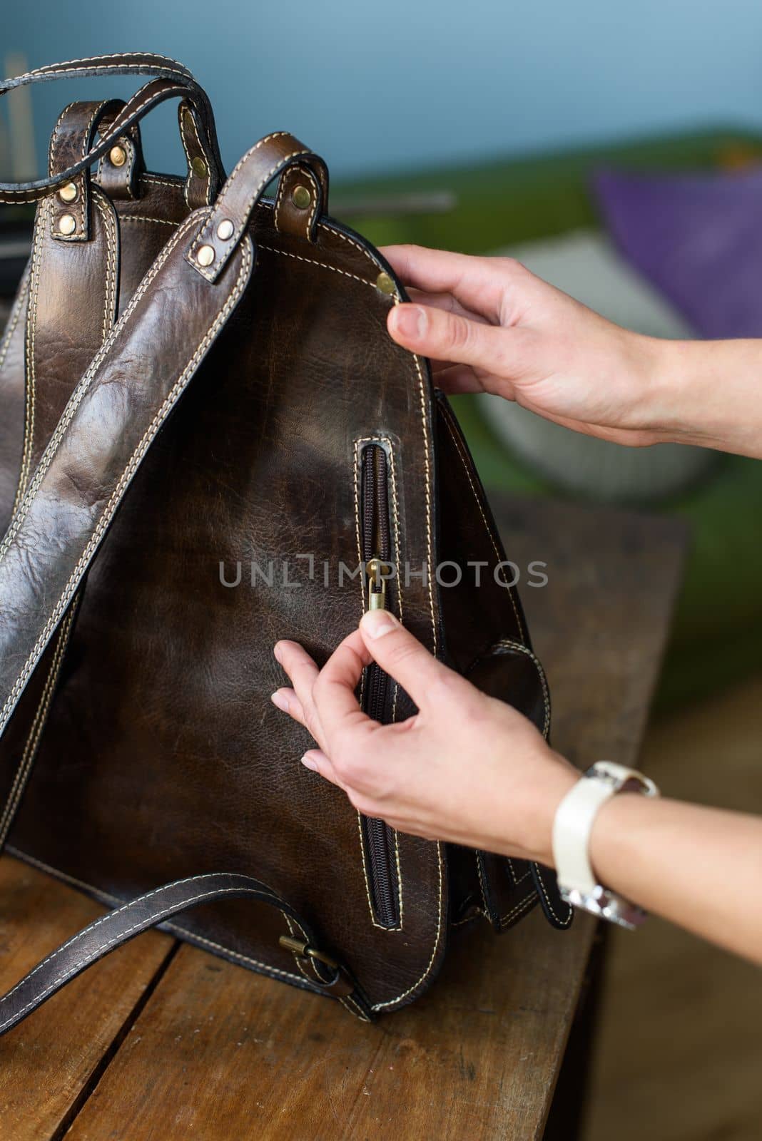 part photo of a brown leather backpack. Indoor photo