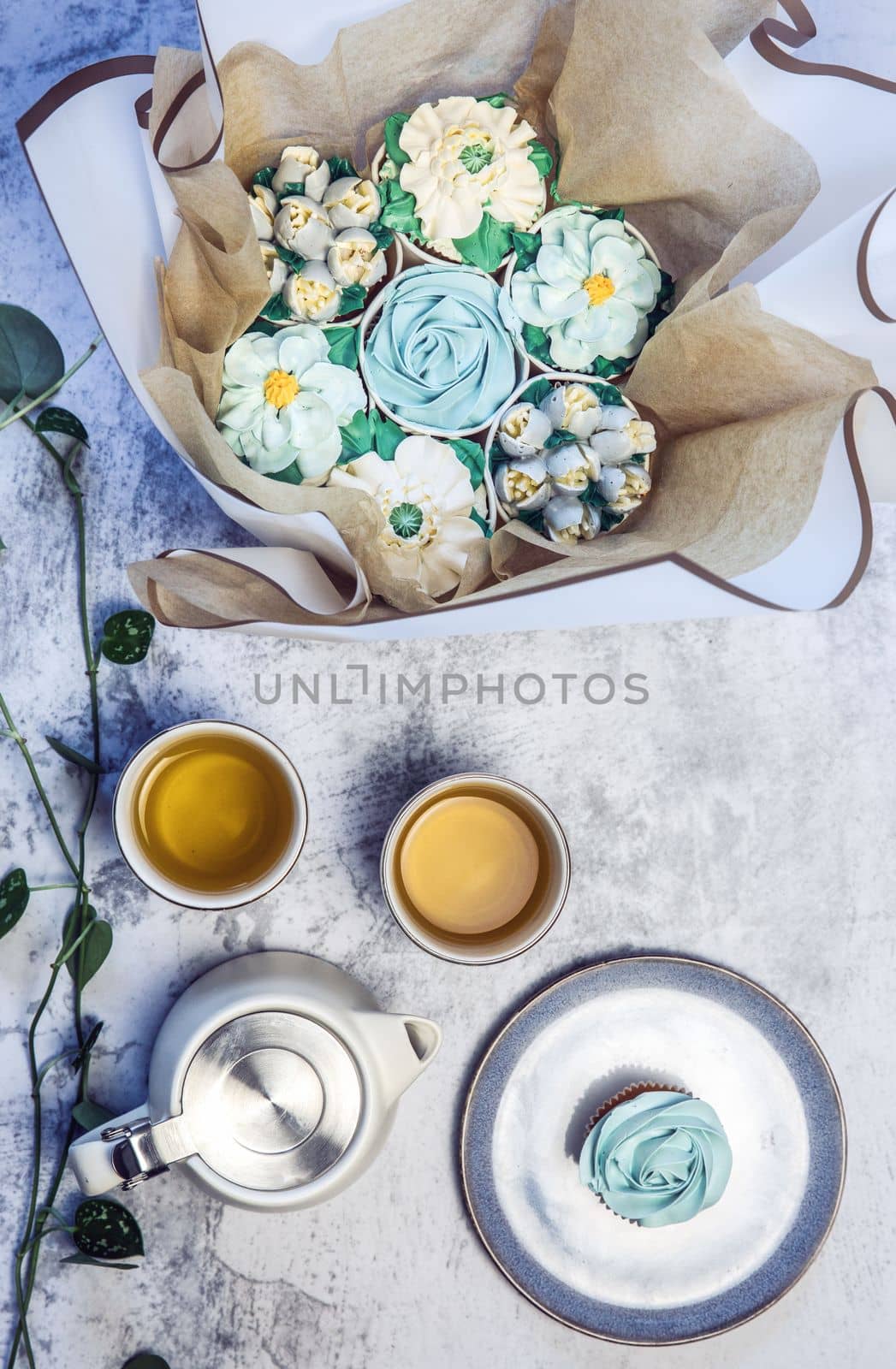 Cupcake decorated with white various colors flower icing isolated on white background. Shoot from top. Floral bouquet. Wedding cupcakes. Mothers Day,Birthday, Valentine Holiday Romantic