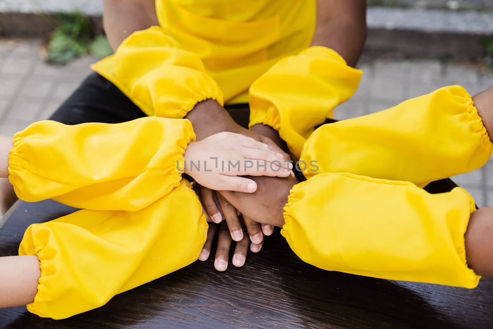 Multiracial children hands together forming pile close-up. Friendship of multinational kids. Childhood