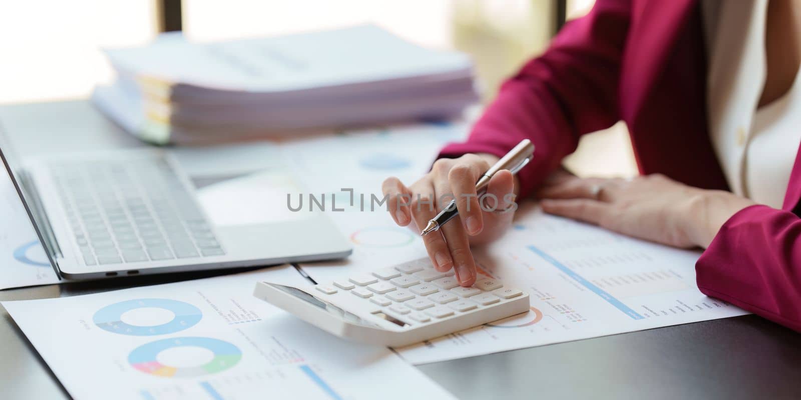 Asian Business woman working at home office and analyze financial report document. Accounting and Finance concept by itchaznong