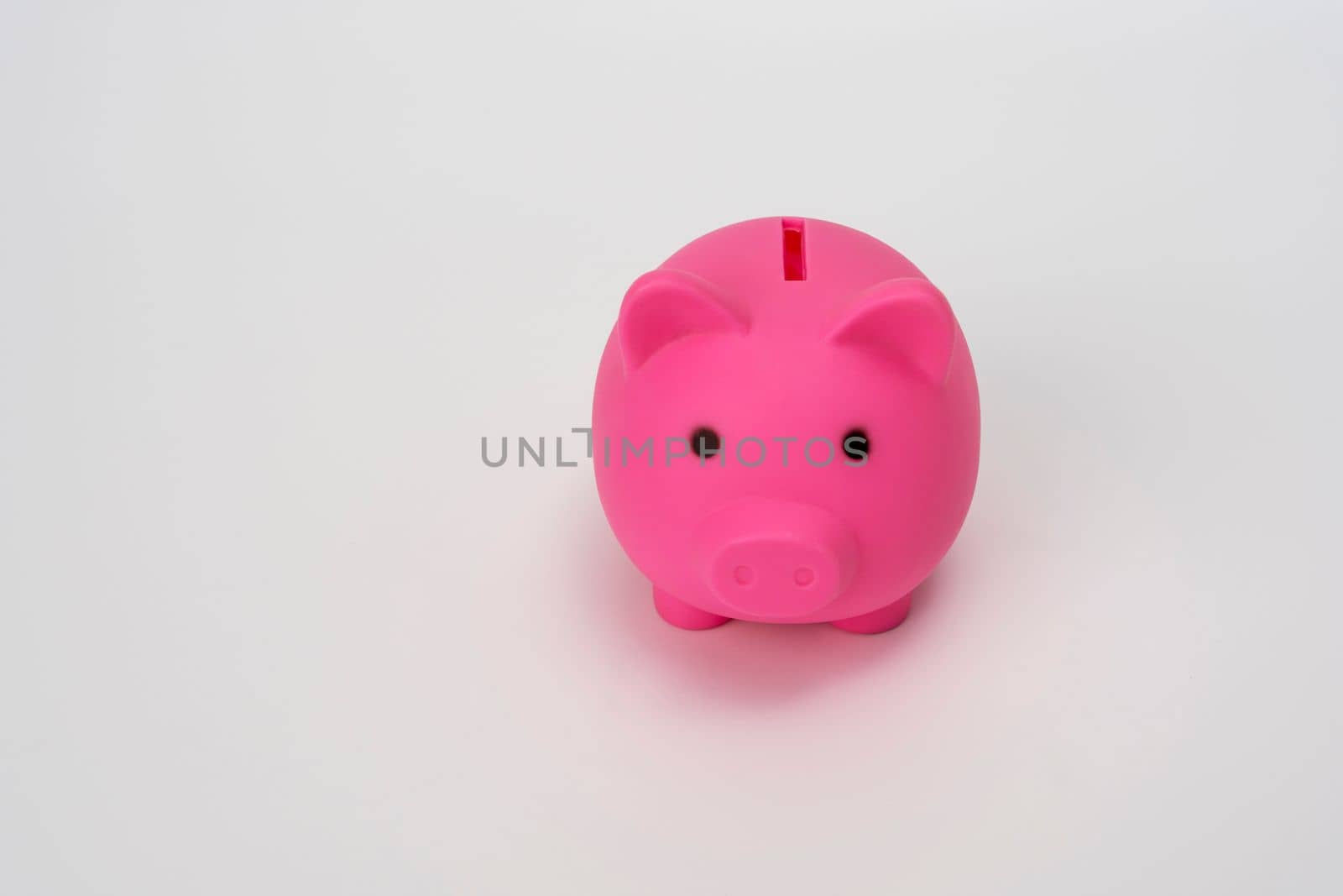Piggy bank pink on a white background. Symbol saving or accumulation of money. The concept of Financial literacy. Investments and savings