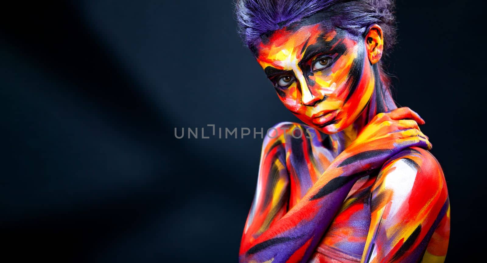 Portrait of the bright beautiful girl with art colorful make-up and bodyart. Download a picture with free space for text. Mockup for a music album. Cover design for e-book. Abstract image by MikeOrlov
