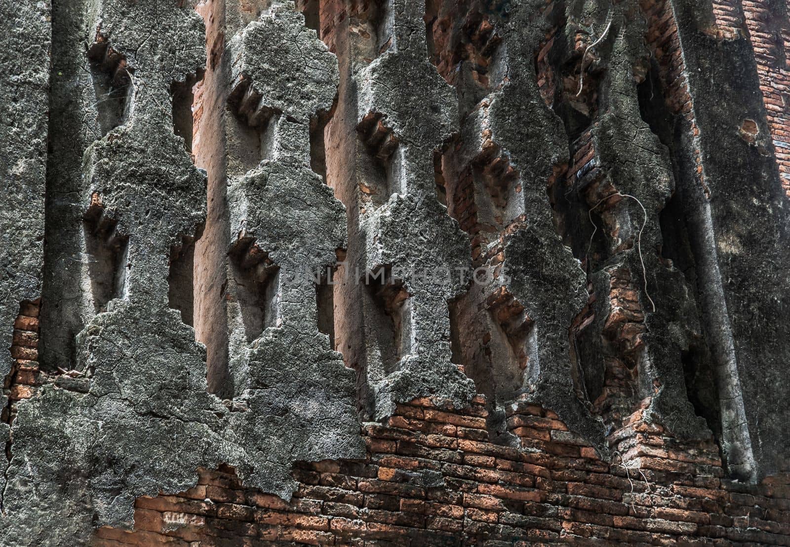 Cracked concrete vintage brick wall background and ventilation holes at the old temple in Ayuthaya. Archaeological area. Pattern on the wall with space for text, No focus, specifically.