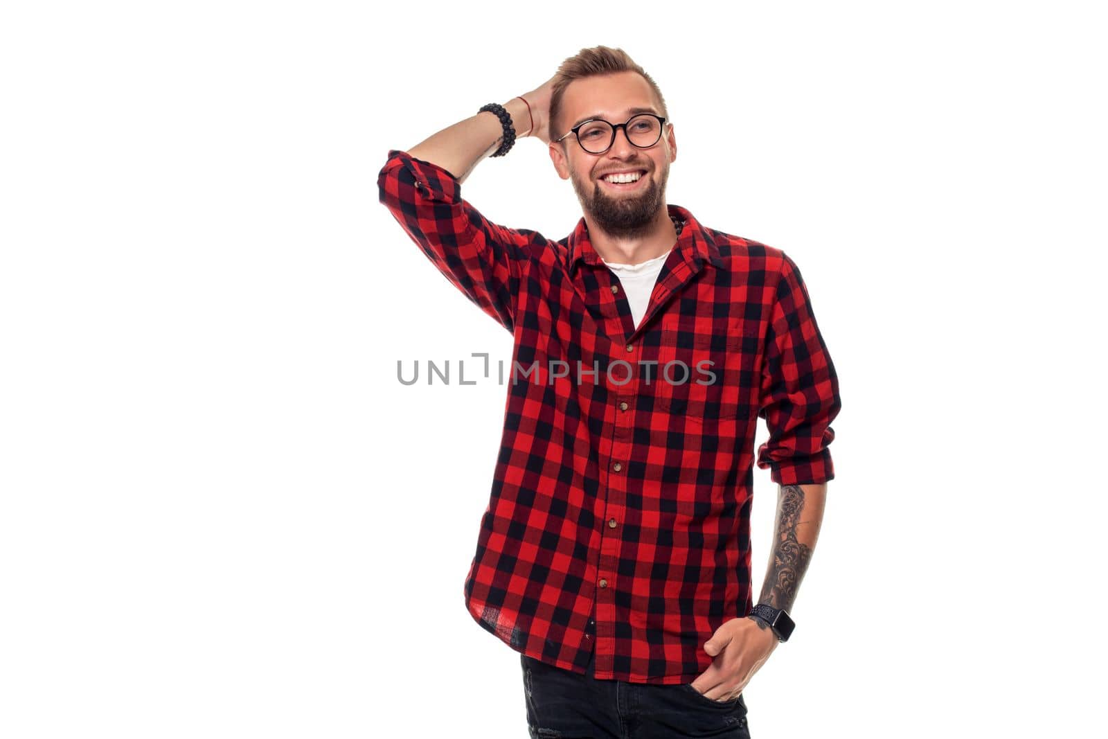 Handsome man model studio portrait. Boy casual style, trendy hipster in checkered shirt look with cool hairstyle. Studio shot on white background. Copy space