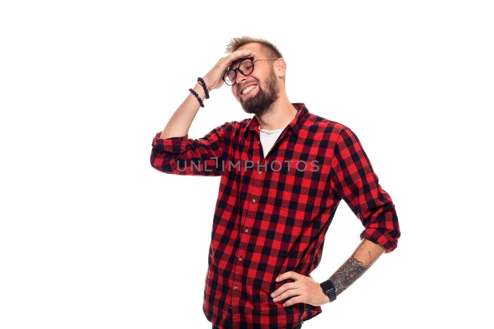 Handsome man model studio portrait. Boy casual style, trendy hipster in checkered shirt look with cool hairstyle. Studio shot on white background. Copy space