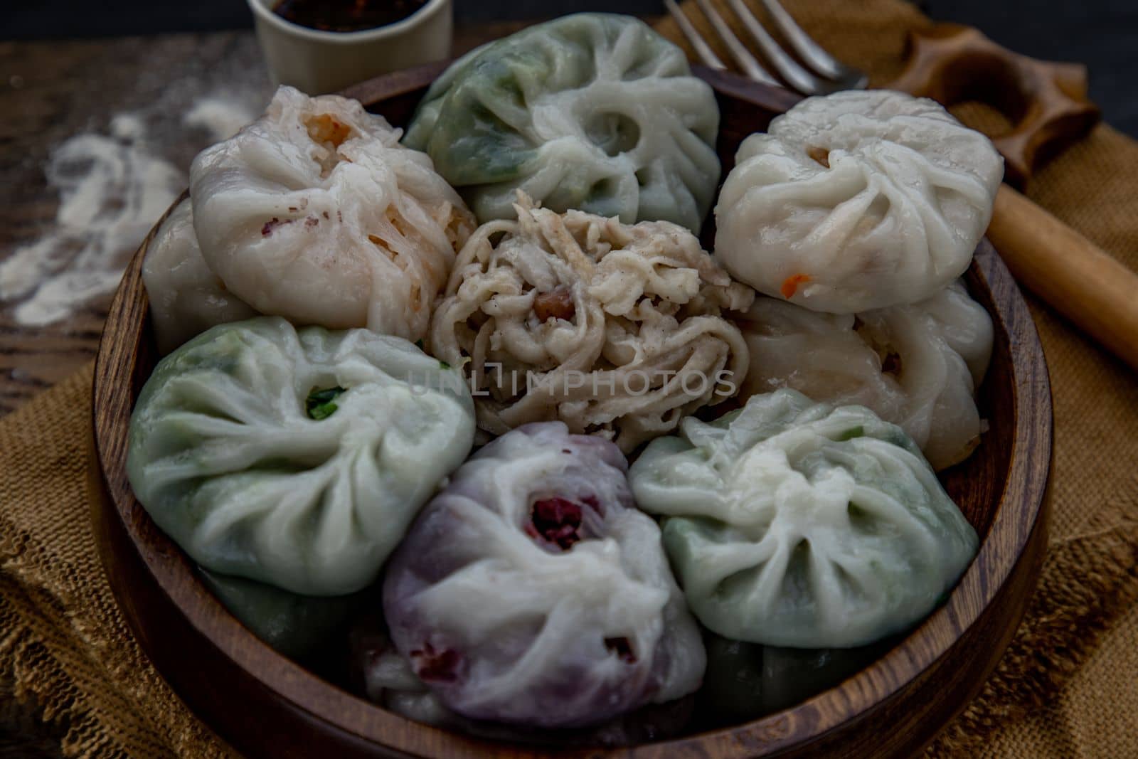 Close-up of Chinese chives Dumplings Mixed Color or Garlic Chives Dim Sum Rice Cake inside with Taro Slice ,Bamboo shoot and Many kind of vegetable inside the flour, Steamed Served Sweet Black Soy Sauce Chinese Food Style side view, Chinese Food Appetizer dish Style.