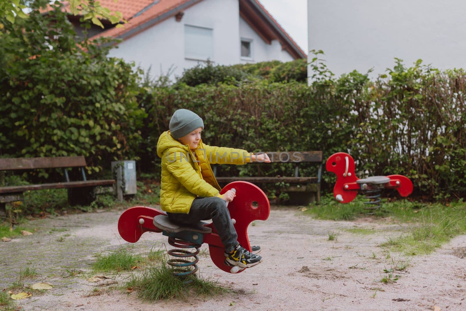 Funny cute happy baby playing on the playground. The emotion of happiness, fun, joy. Smile of a child. boy playing on the playground by Andrii_Ko