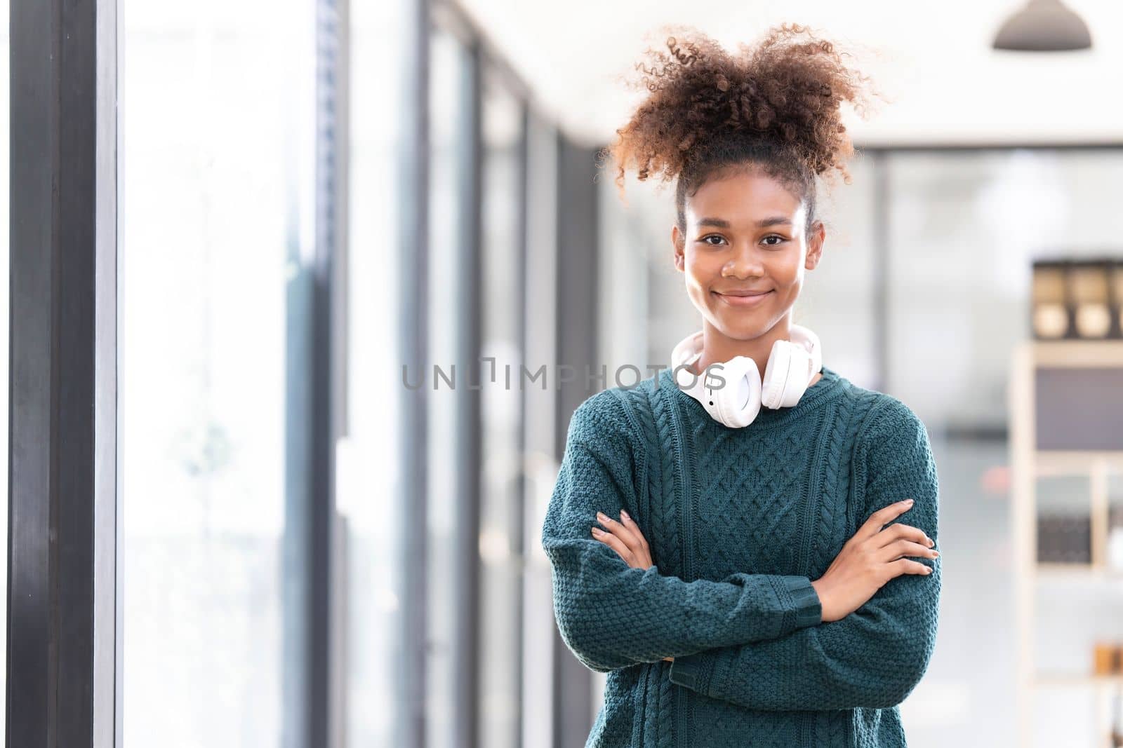 Portrait of smiling young black woman listening music with headset and digital tablet..