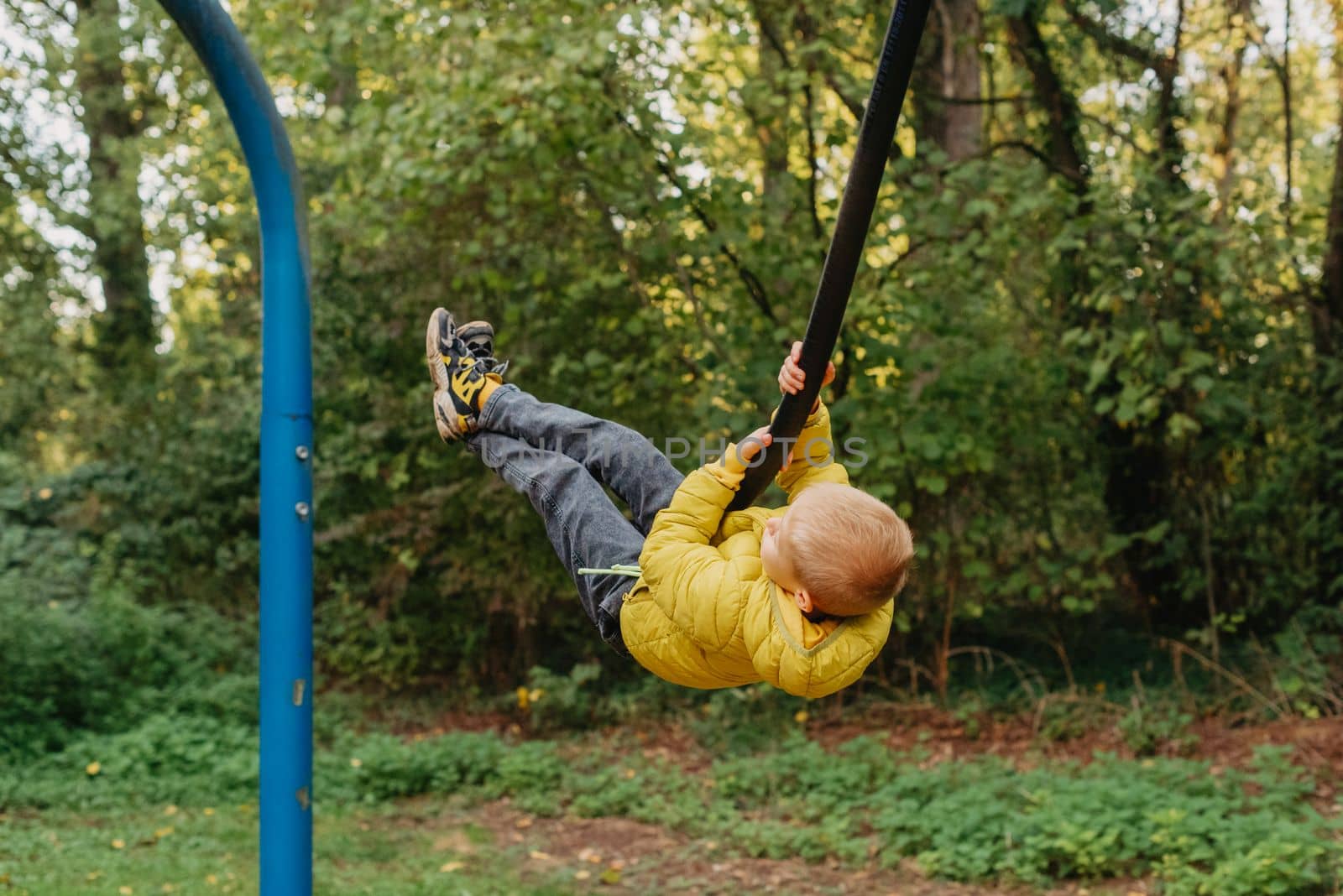 Kid Bungee jumping in the Autumn Forest. by Andrii_Ko