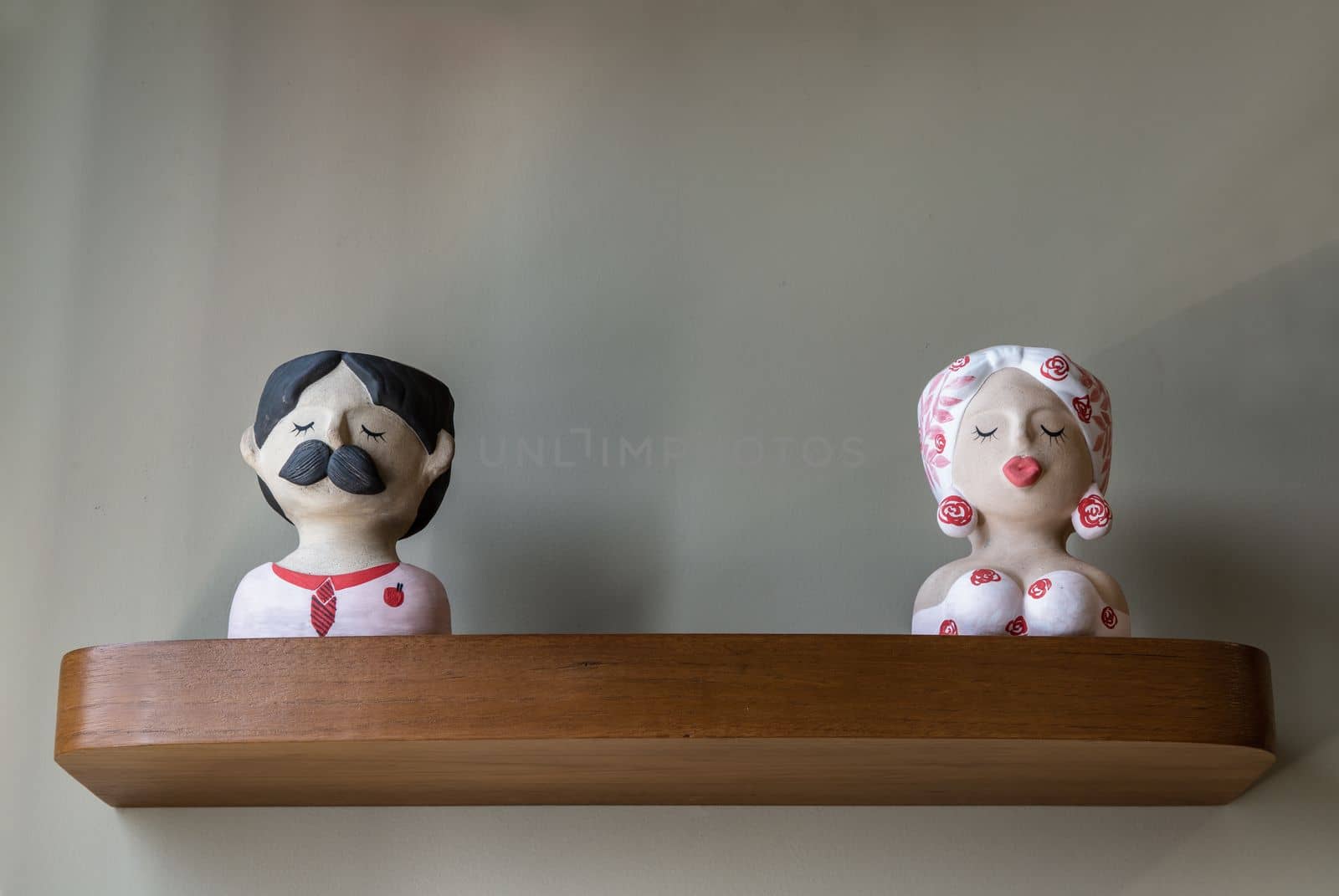 Bangkok, Thailand - Apr 11, 2021 :  Male and female clay figurines ceramic dolls for home decoration or being a gift. Copy space, Selective focus.