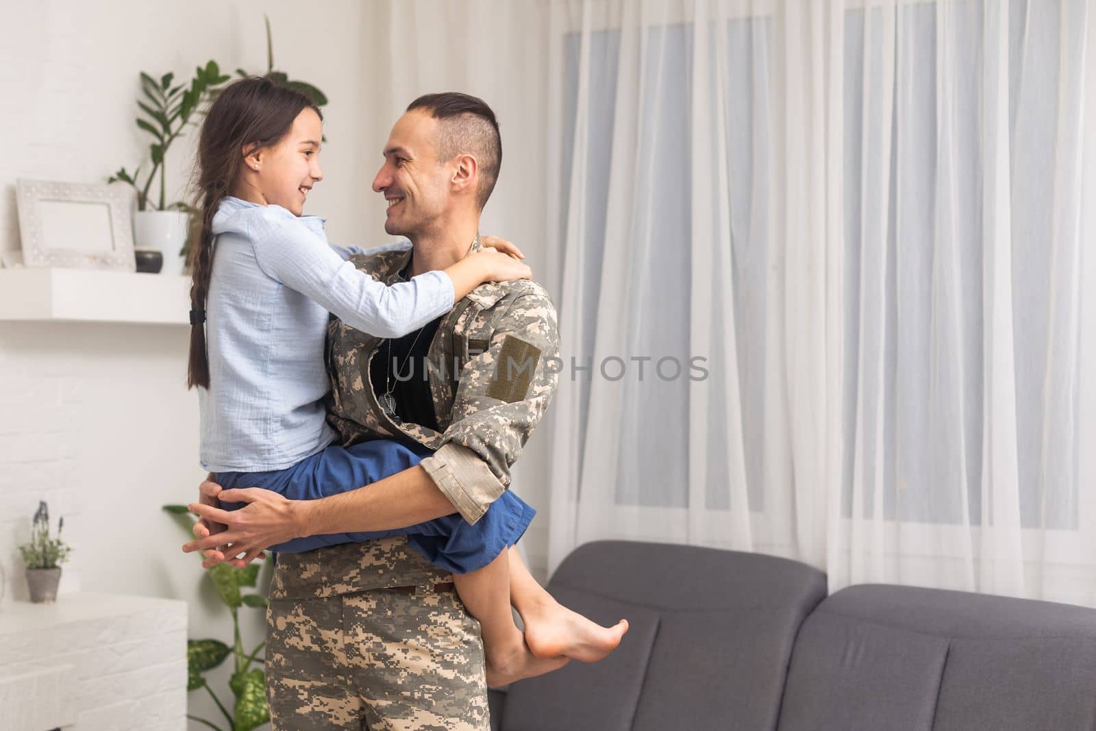 military father hugging his daughter