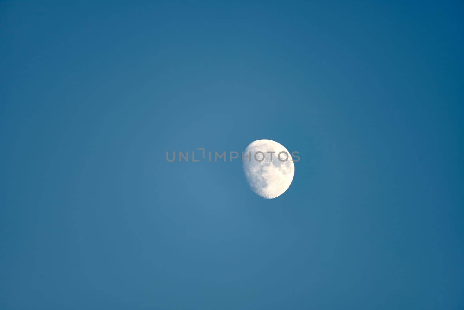 An almost full moon on a blue background by raul_ruiz
