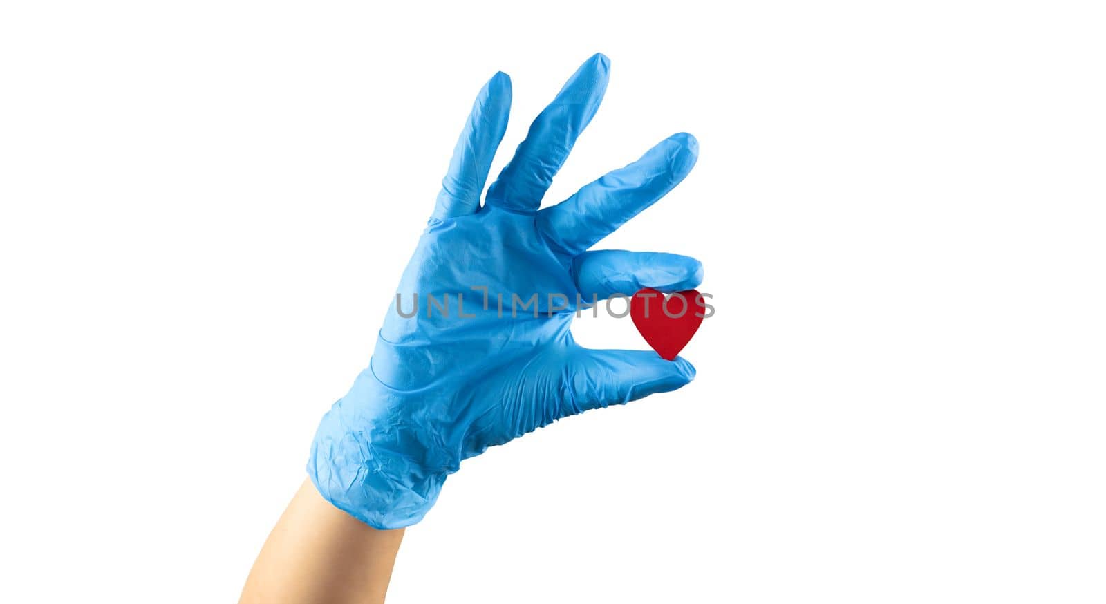 hand in blue medicine glove holding wooden red heart with two fingers showing it isolated on white background by Kondrateva