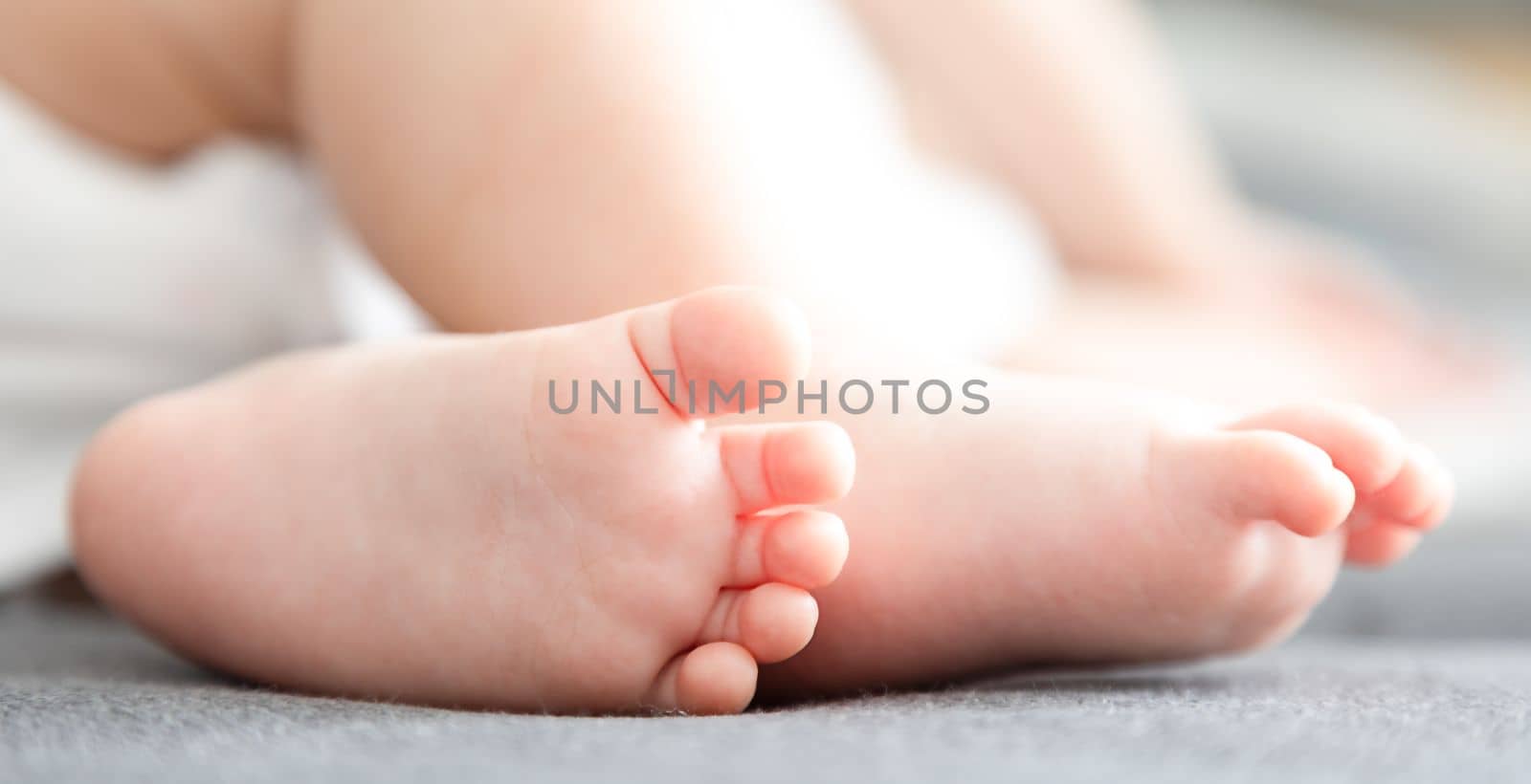 infant baby feet close-up view by Kondrateva