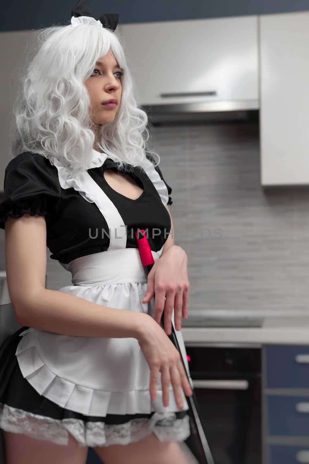 sexy girl in a governess costume for sexy adult games in the kitchen