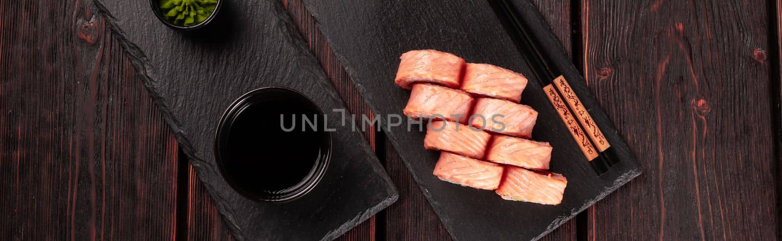 Banner Roll with fish sushi and chopsticks top view copy space - asian food concept by Satura86