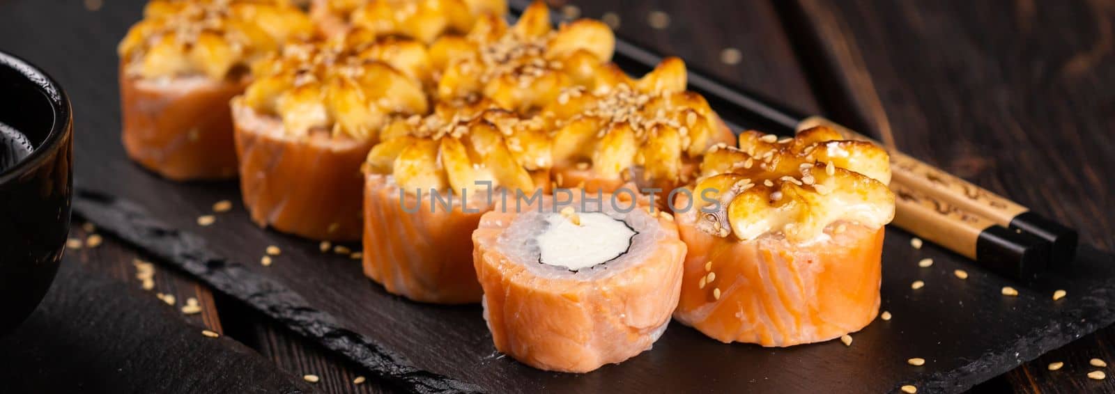 Banner Roll with fish sushi with chopsticks close-up - asian food concept by Satura86