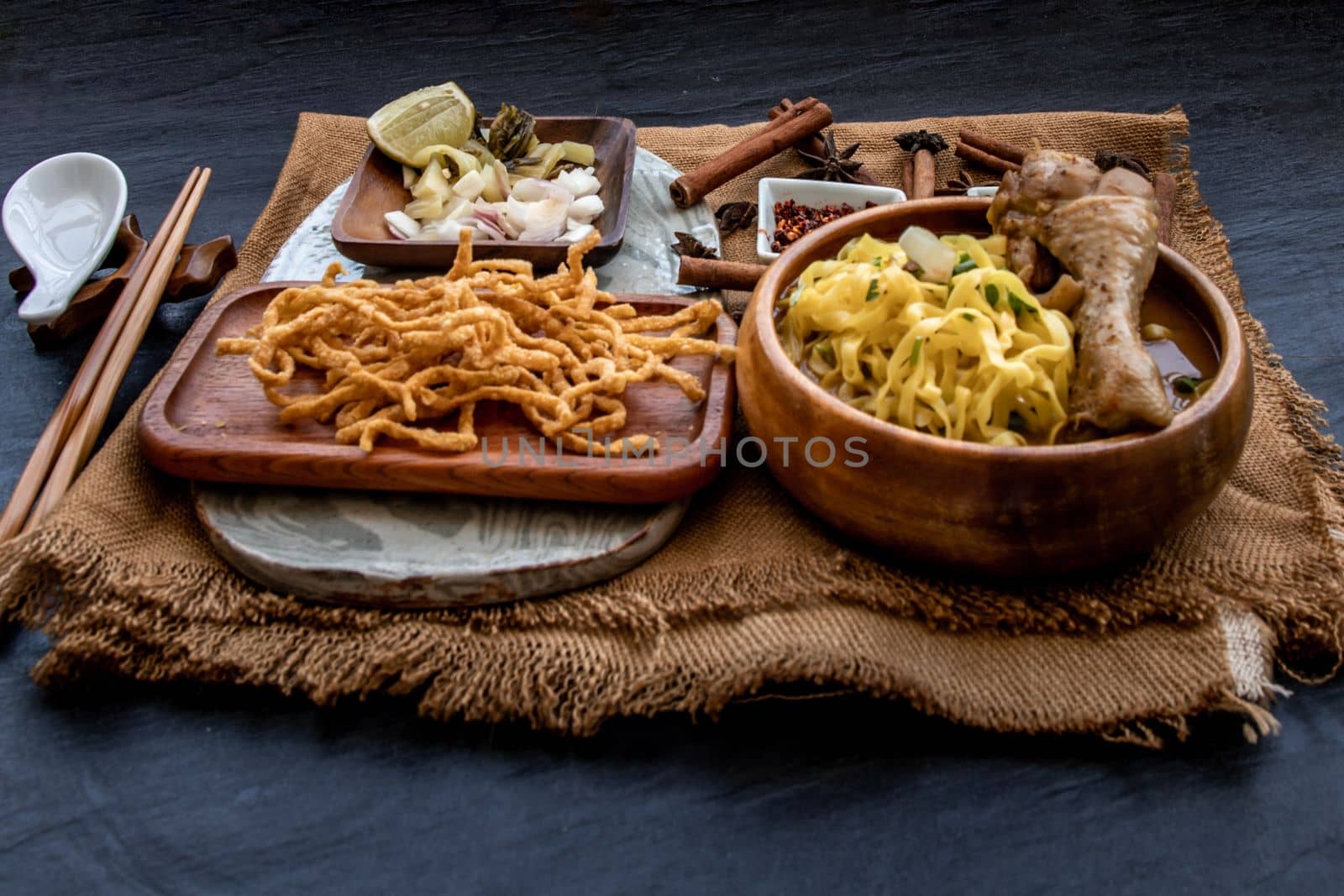 Northern Style Curried Noodle Soup with coconut milk (Khao soi), Traditional of Northern Thai cuisine, Oblique view from the top.
