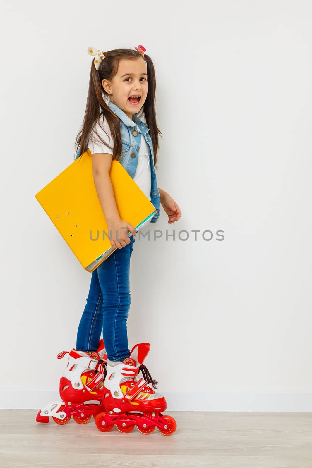 Cute girl on roller skates against white background. by Andelov13