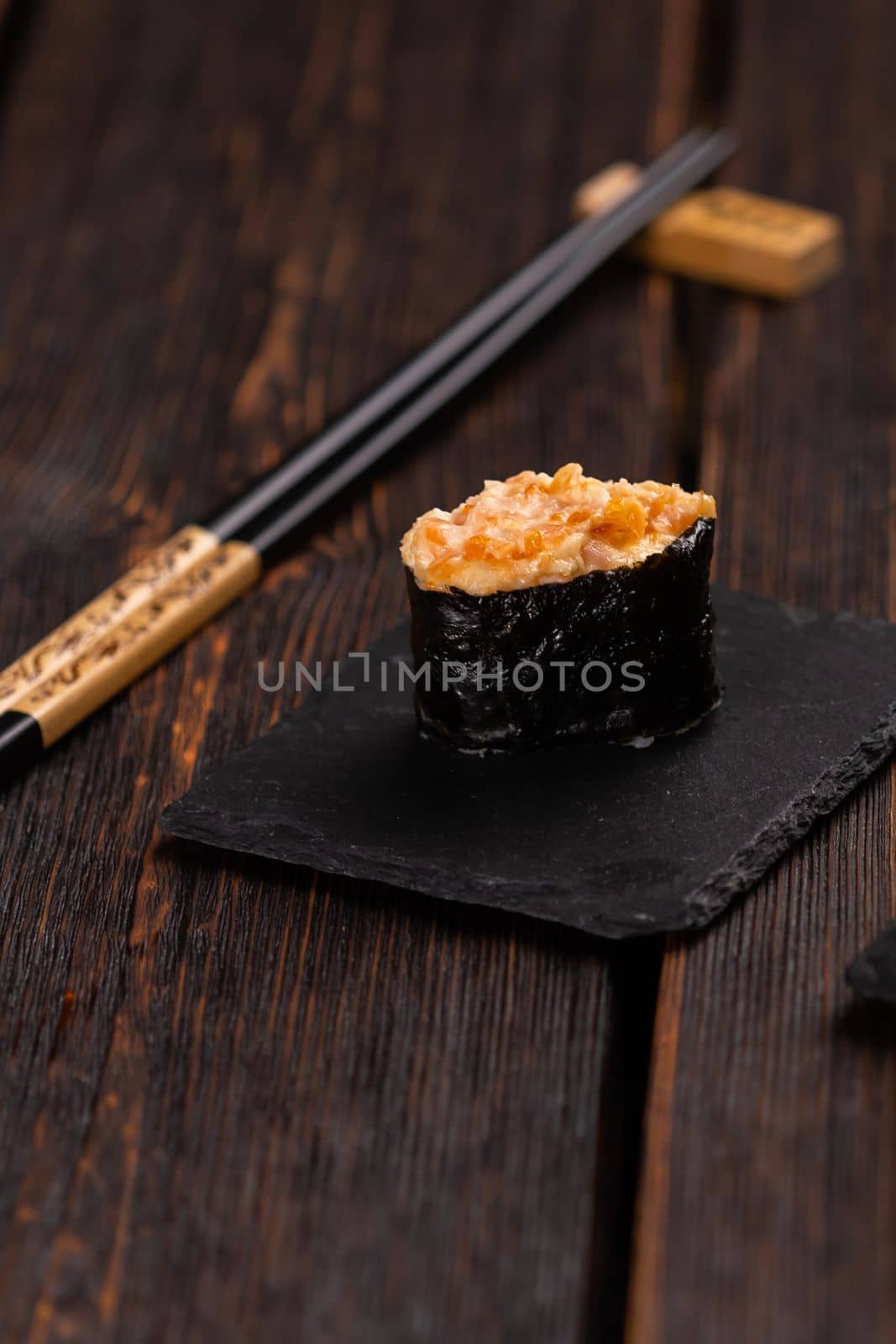 Set of Gunkan Maki Sushi with different types of fish salmon, scallop, perch, eel, shrimp and caviar on wooden table background. Sushi menu. Japanese food sushi set gunkan