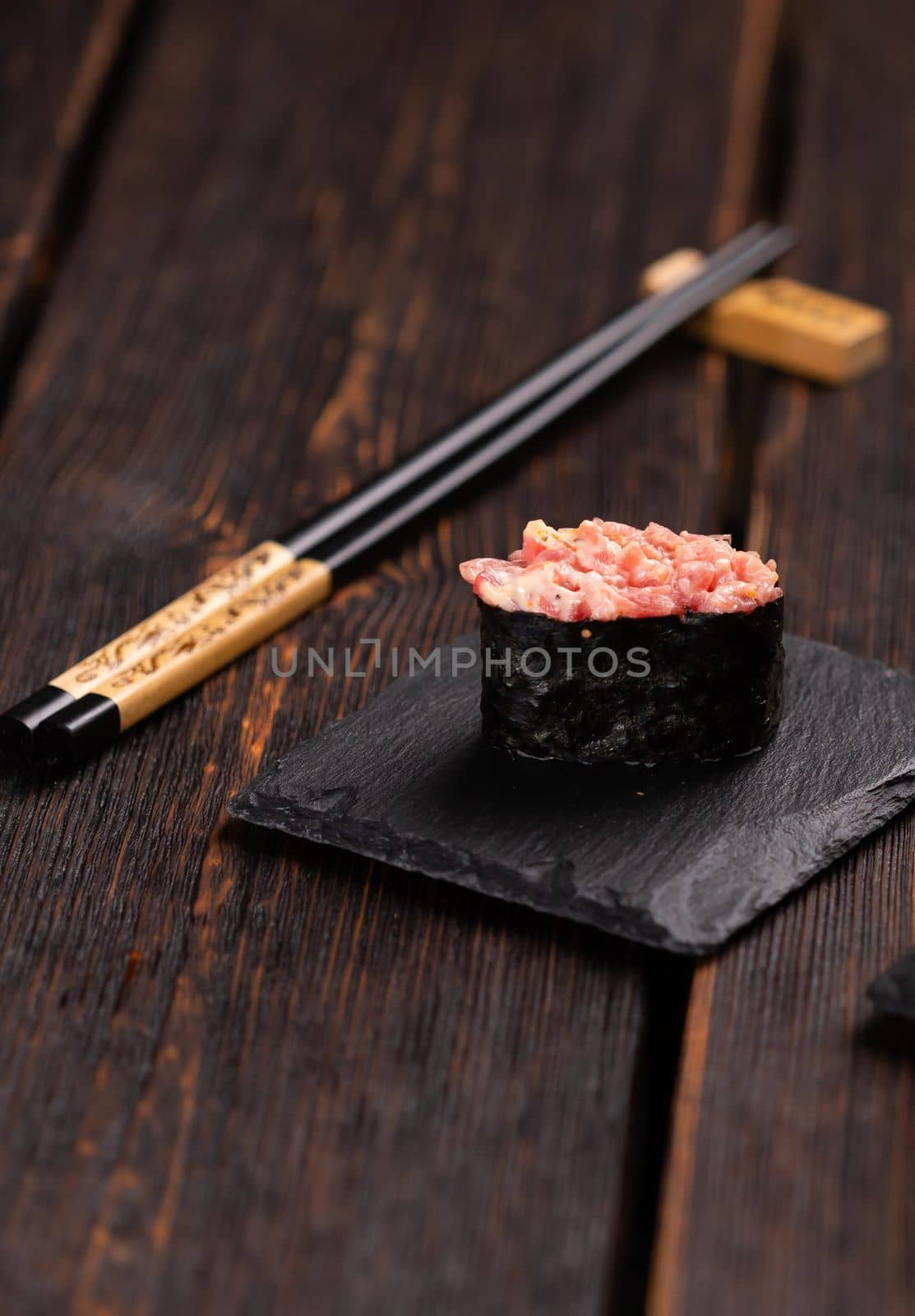 Set of Gunkan Maki Sushi with different types of fish salmon, scallop, perch, eel, shrimp and caviar on wooden table background. Sushi menu. Japanese food sushi set gunkan