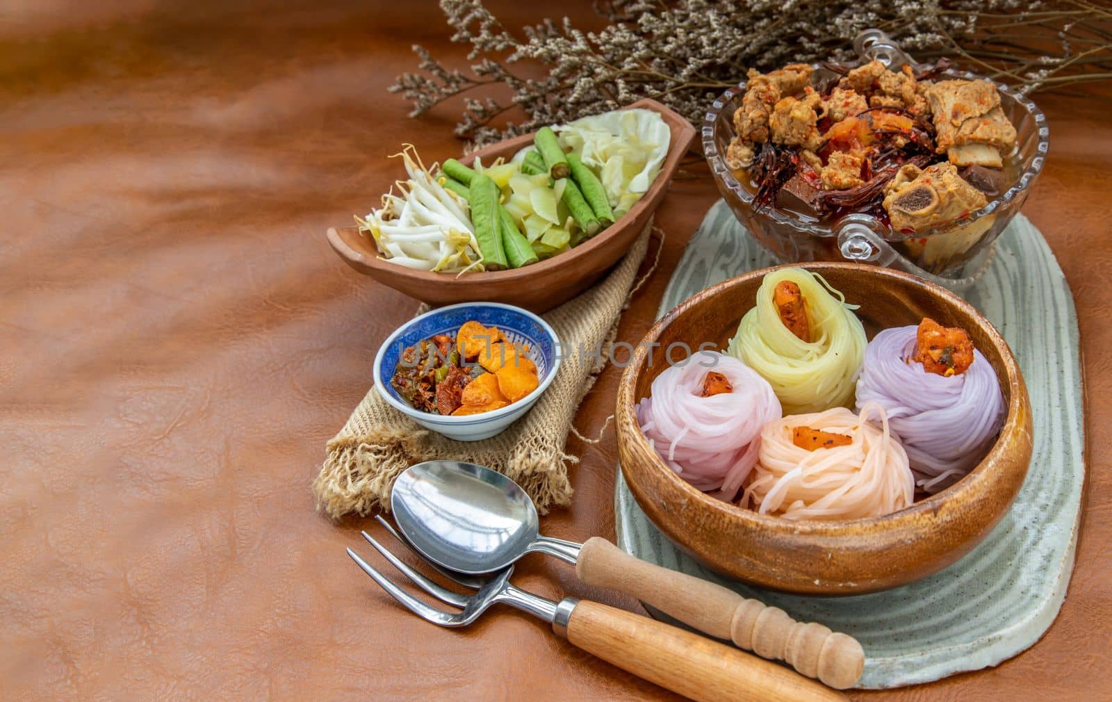Rice noodles with spicy pork sauce or Nam ngiao Rice Noodle (Traditional Northern Thai Cuisine). Nam ngiao has a characteristic spicy and tangy flavor Served with vegetable. Thai spicy food.