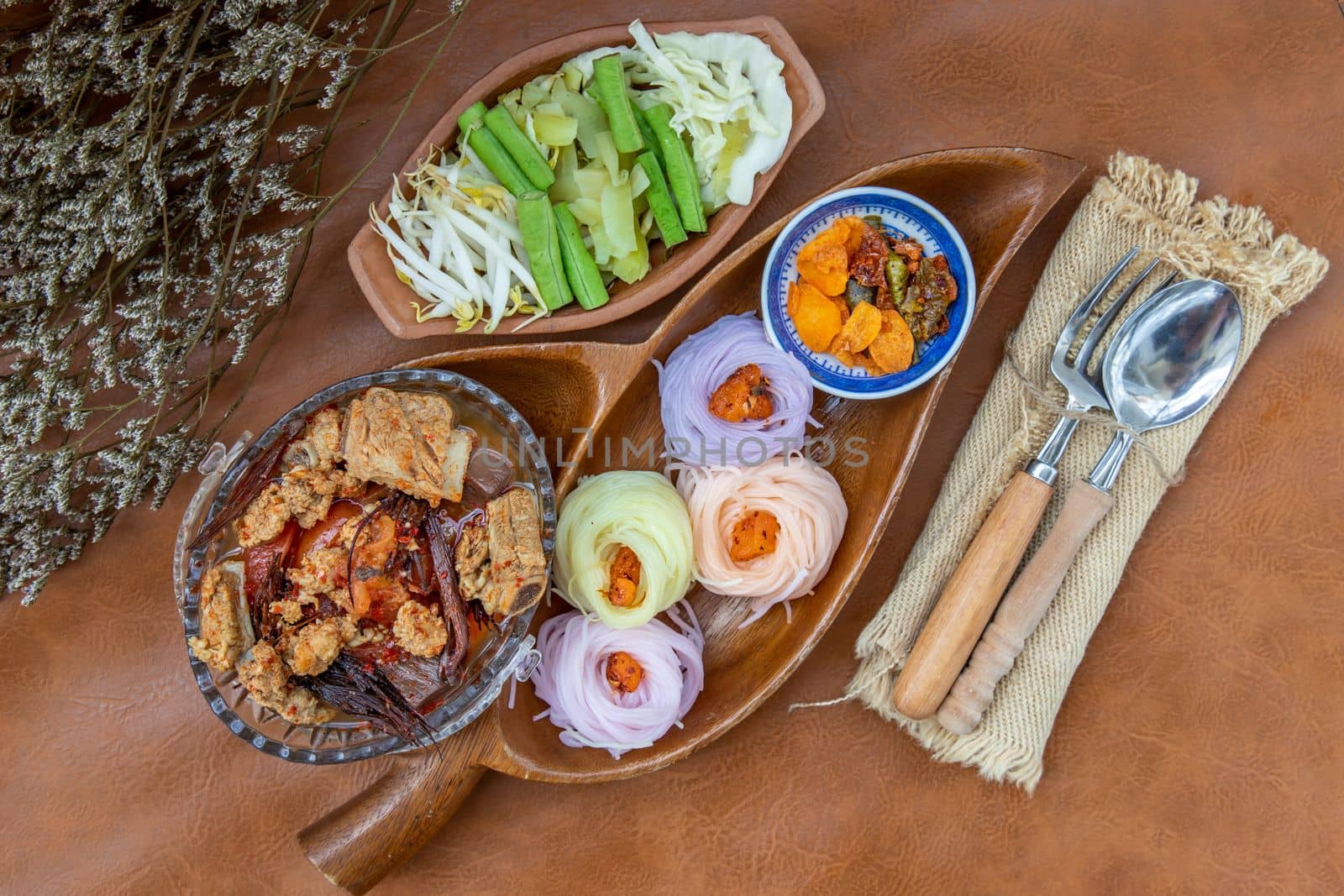 Rice noodles with spicy pork sauce or Nam ngiao Rice Noodle (Traditional Northern Thai Cuisine). Nam ngiao has a characteristic spicy and tangy flavor Served with vegetable. Thai spicy food.