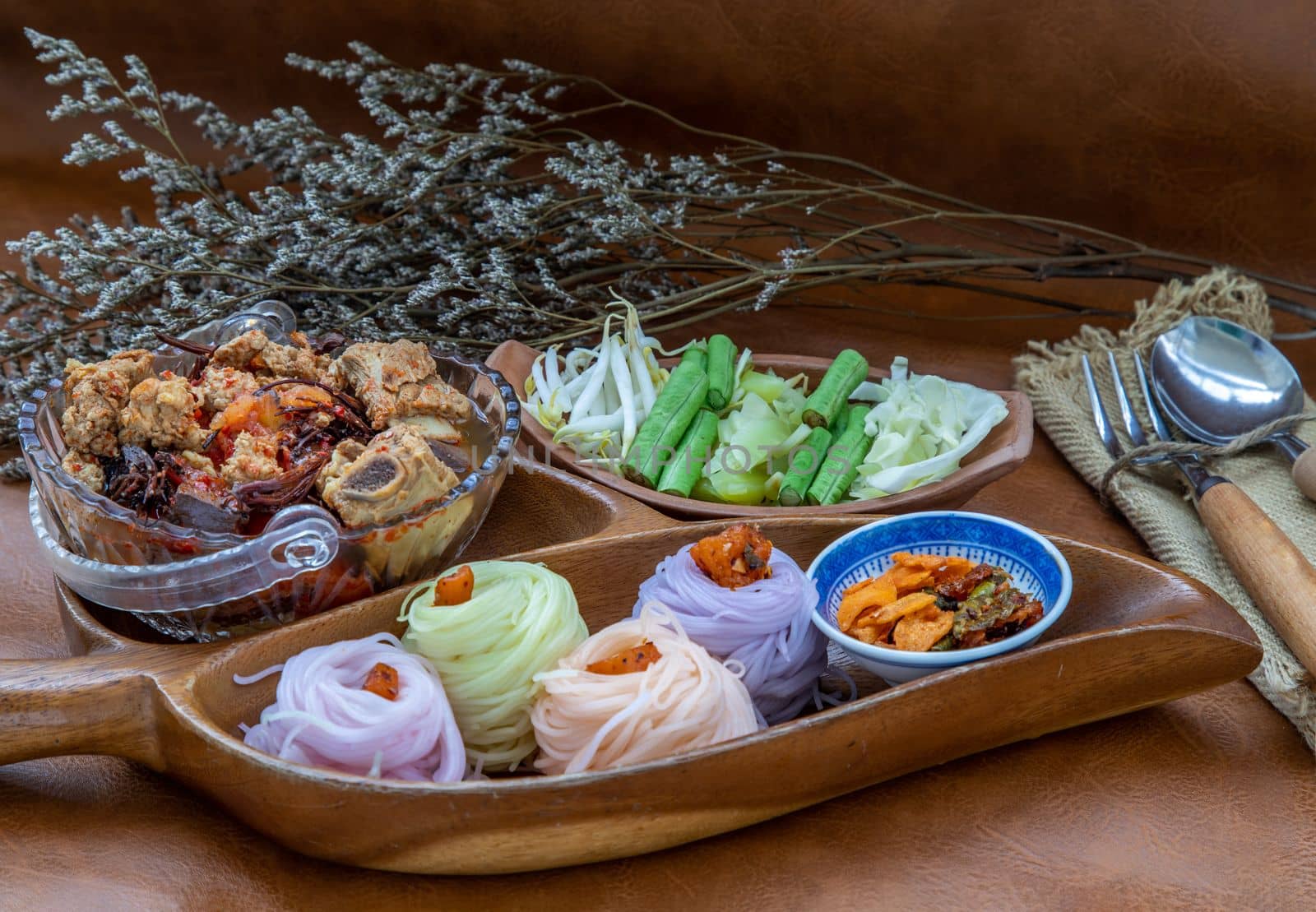 Rice noodles with spicy pork sauce or Nam ngiao Rice Noodle (Traditional Northern Thai Cuisine). Nam ngiao has a characteristic spicy and tangy flavor Served with vegetable. Thai spicy food.