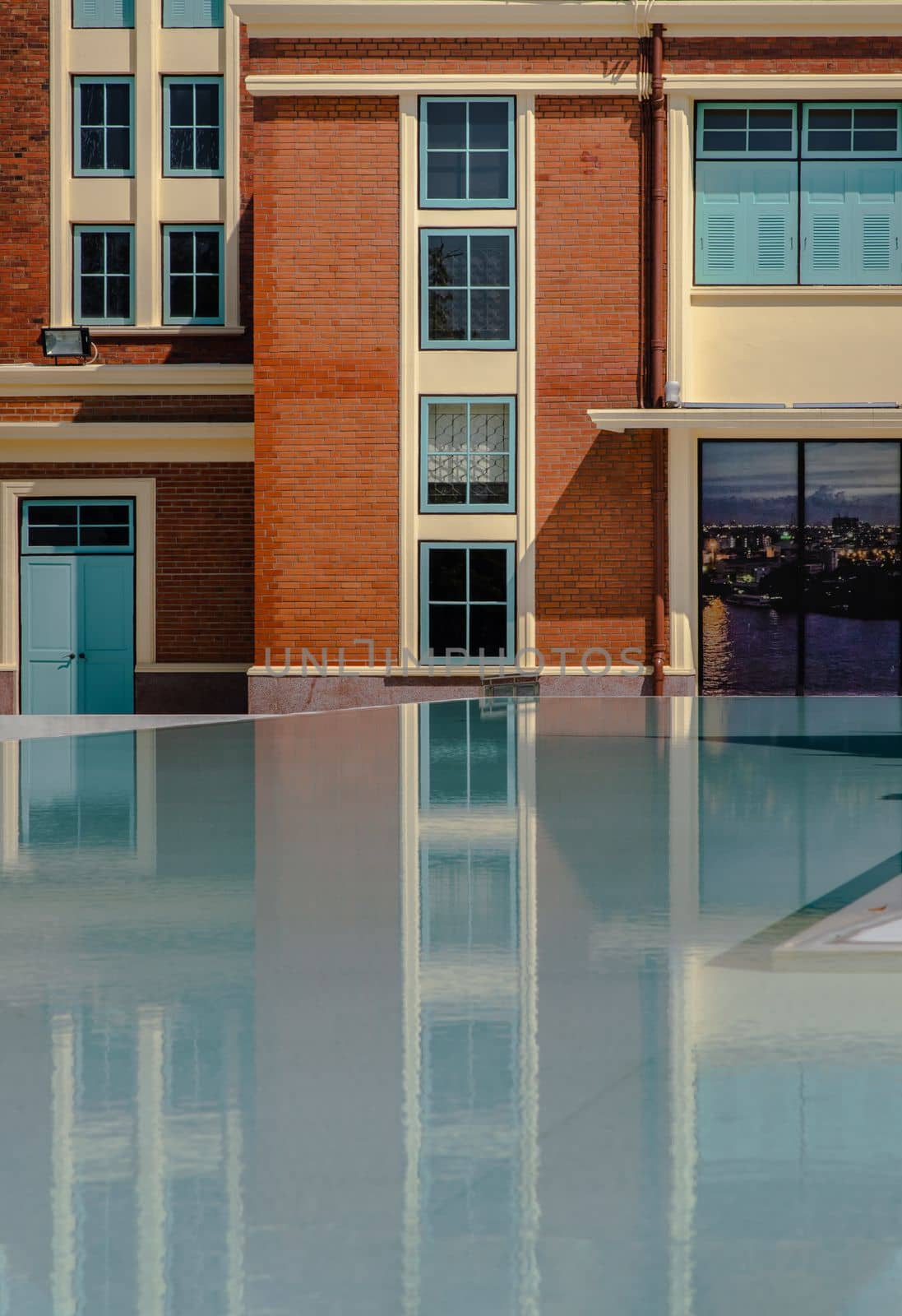 Bangkok, Thailand - Nov 15, 2020 : Siriraj Bimuksthan Museum with reflections in the water. Vintage-style building. Selective focus.