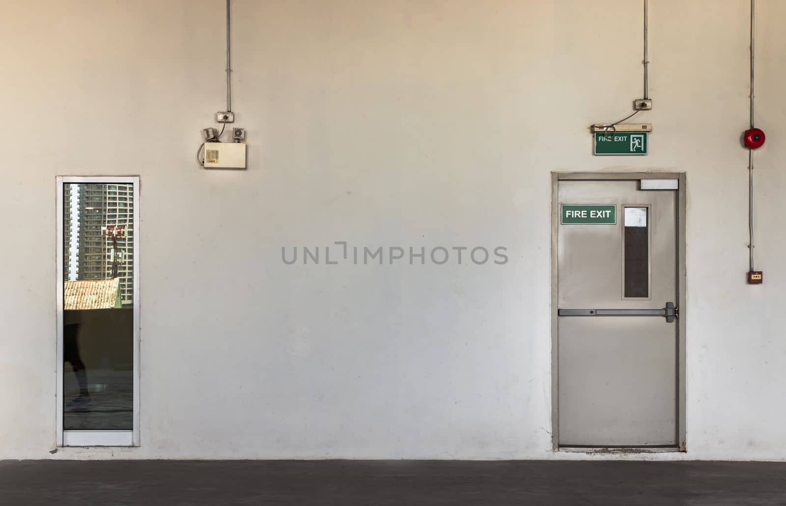 Fire exit door for emergency case with alarm for safety protection of the car parking  building near the Condominium building. Safety first concept, Copy space, Selective focus.