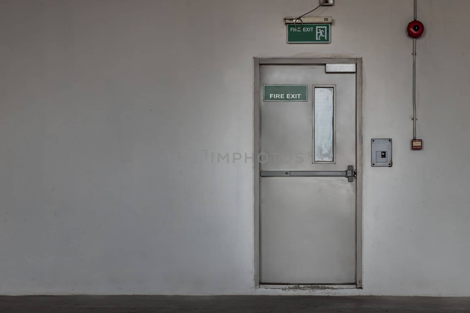 Fire exit door for emergency case with alarm for safety protection of the car parking  building near the Condominium building. Safety first concept, Copy space, Selective focus.