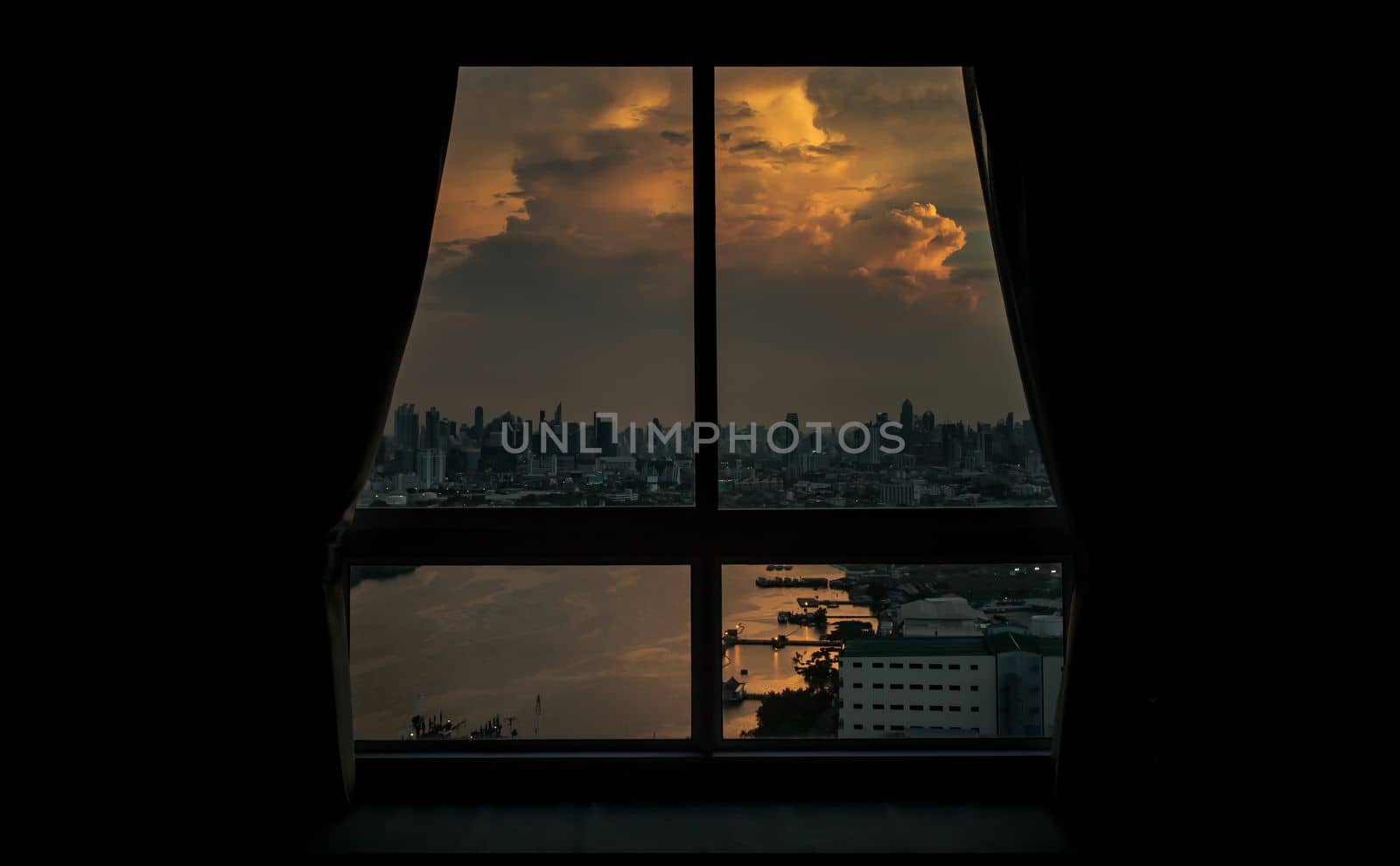 Bangkok, Thailand - 10 May, 2021 : Beautiful City with River view at evening. Can see through glass windows in the bedroom at bangkok. Selective focus.