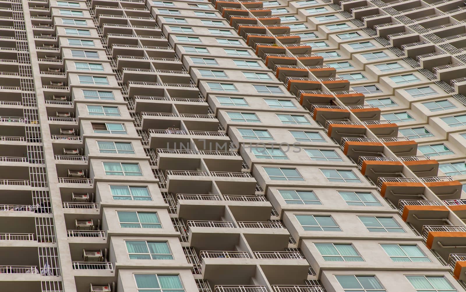 Bangkok, Thailand - 26 Jun 2021 : Pattern from windows and balconies of modern residential building. Abstract composition, Element of architecture concept. Selective focus.
