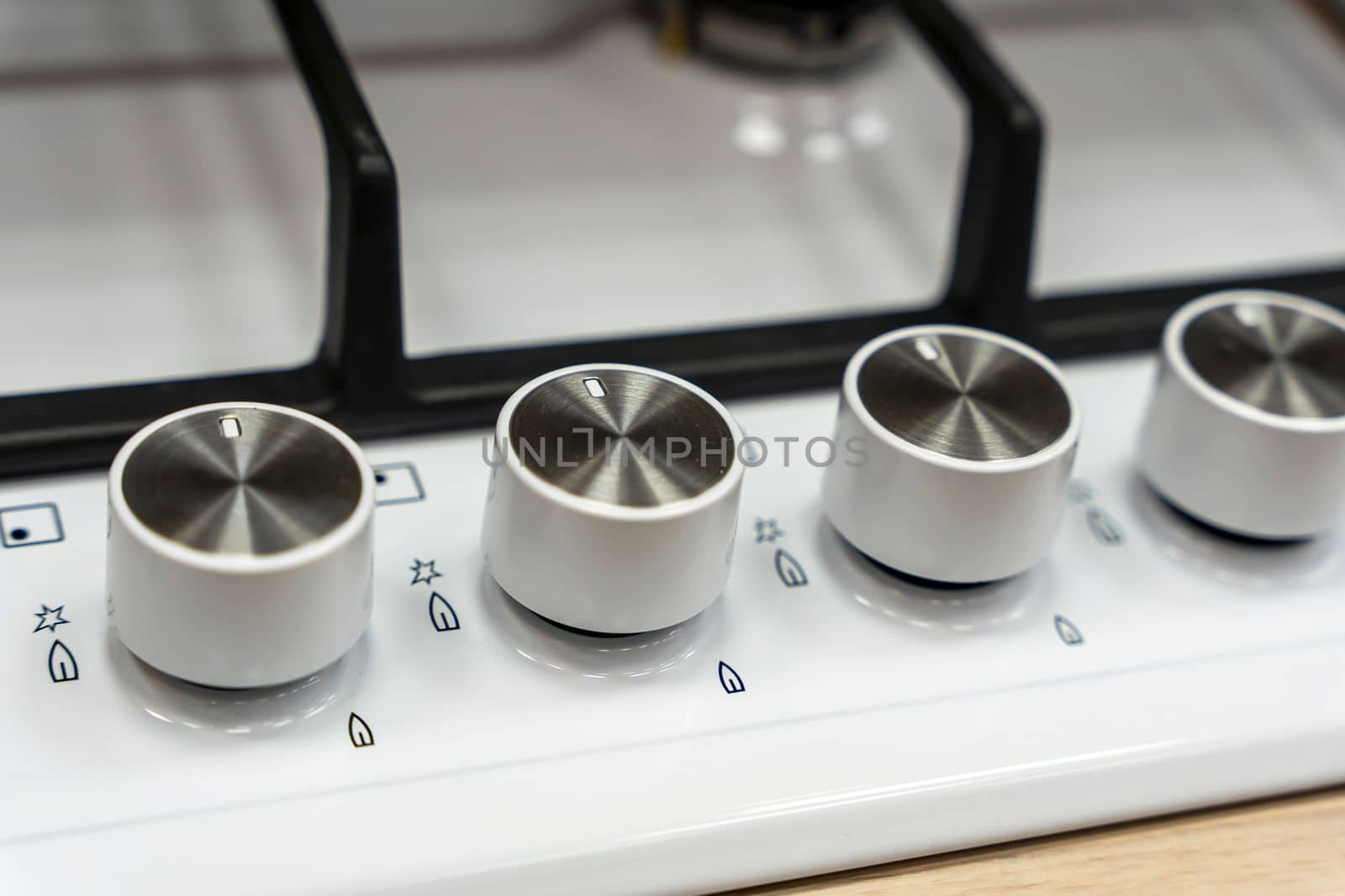the handle for turning on the burner of a home kitchen stove. close-up. Home gas stove. The job in the kitchen. Control knobs of electric stove close-up