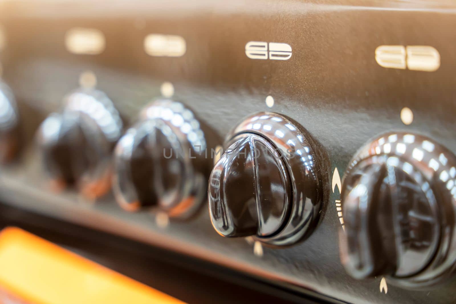the handle for turning on the burner of a home kitchen stove. close-up. Home gas stove. The job in the kitchen. Control knobs of electric stove close-up