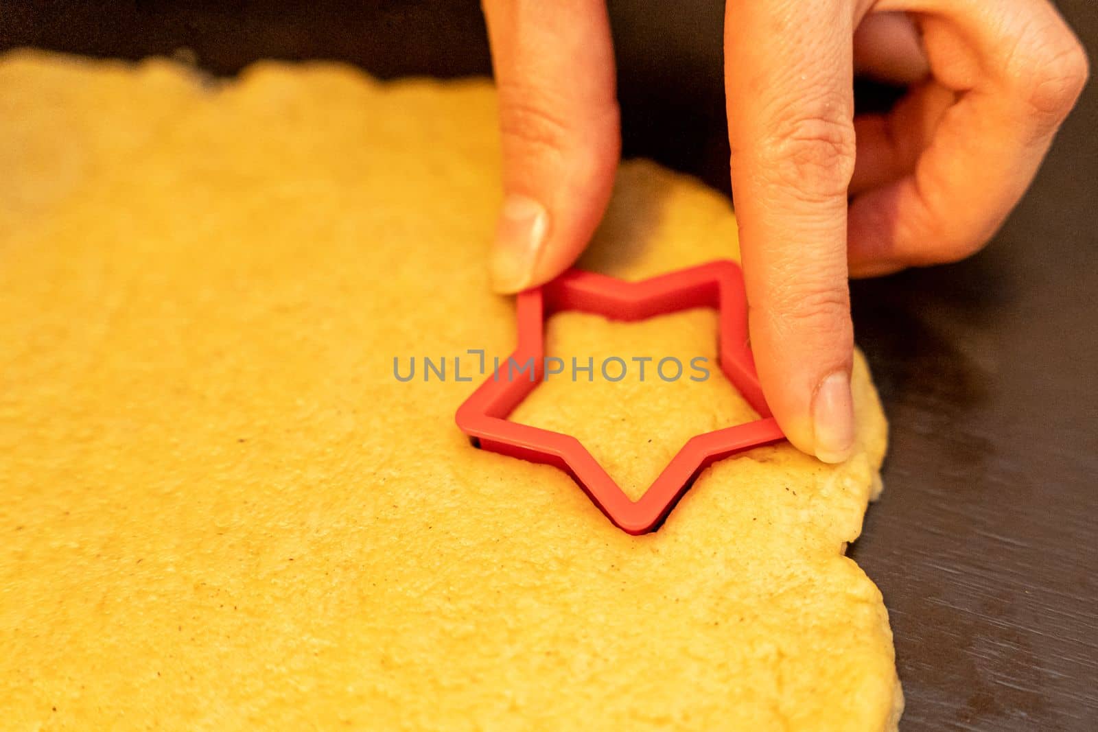 Dough, cookie cutters, mold. Dough for preparing cookies. molds on table. hands making cookies. cutting the dough with the molding trim.