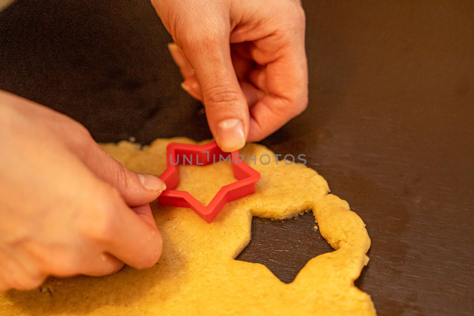 Dough, cookie cutters, mold. Dough for preparing cookies. molds on table. hands making cookies. cutting the dough with the molding trim.