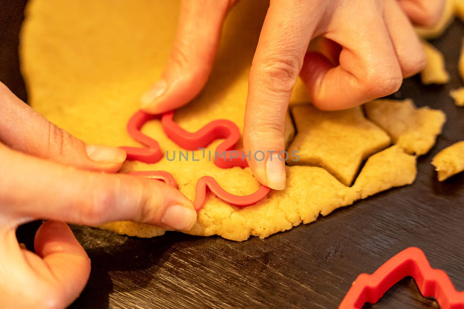 Dough, cookie cutters, mold. Dough for preparing cookies. molds on table. hands making cookies. cutting the dough with the molding trim.