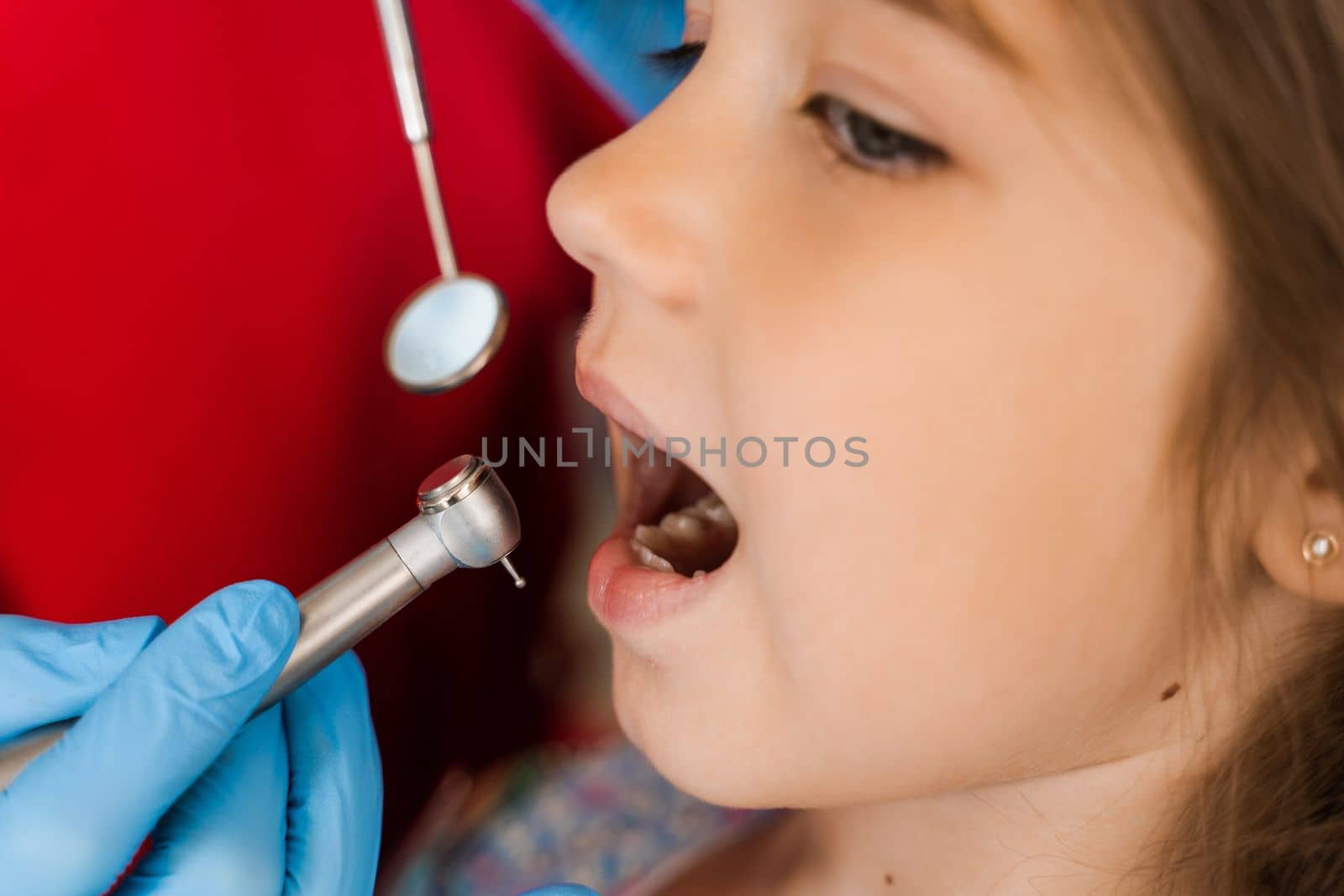 Dental drill close-up. Child dentist drilling teeth of kid girl in dentistry clinic. Teeth treatment. Dental filling for child patient